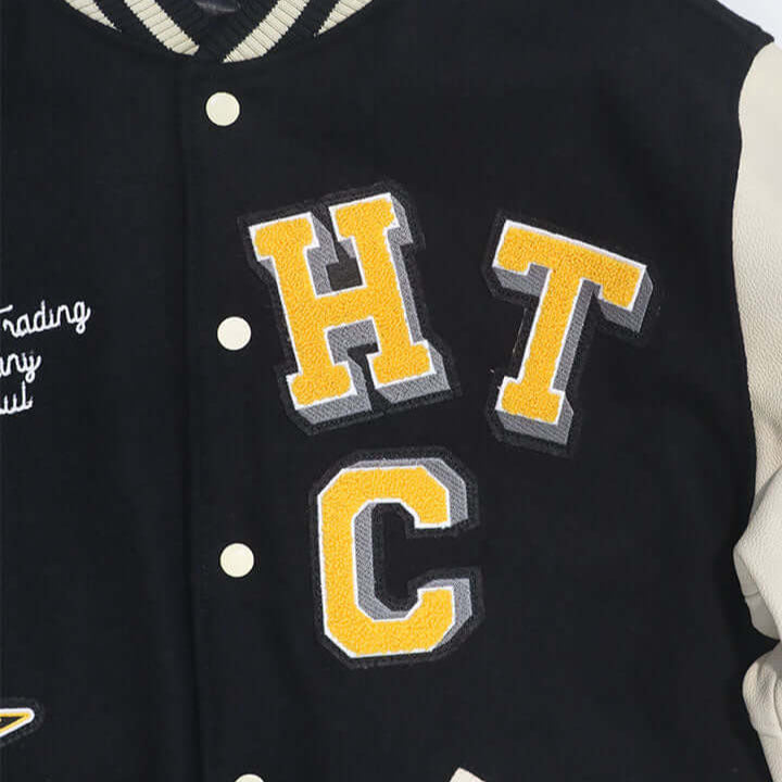 HTC LOS ANGELES HTC VARSITY JACKET BLACK HTC VARSITY JACKET BLACK Limited edition for Seoul. Varsity wool & leather bomber jacket. Front button closure, ribbed collar, cuffs and hem. Embroidered details and patches. Two side pockets. Main body composition