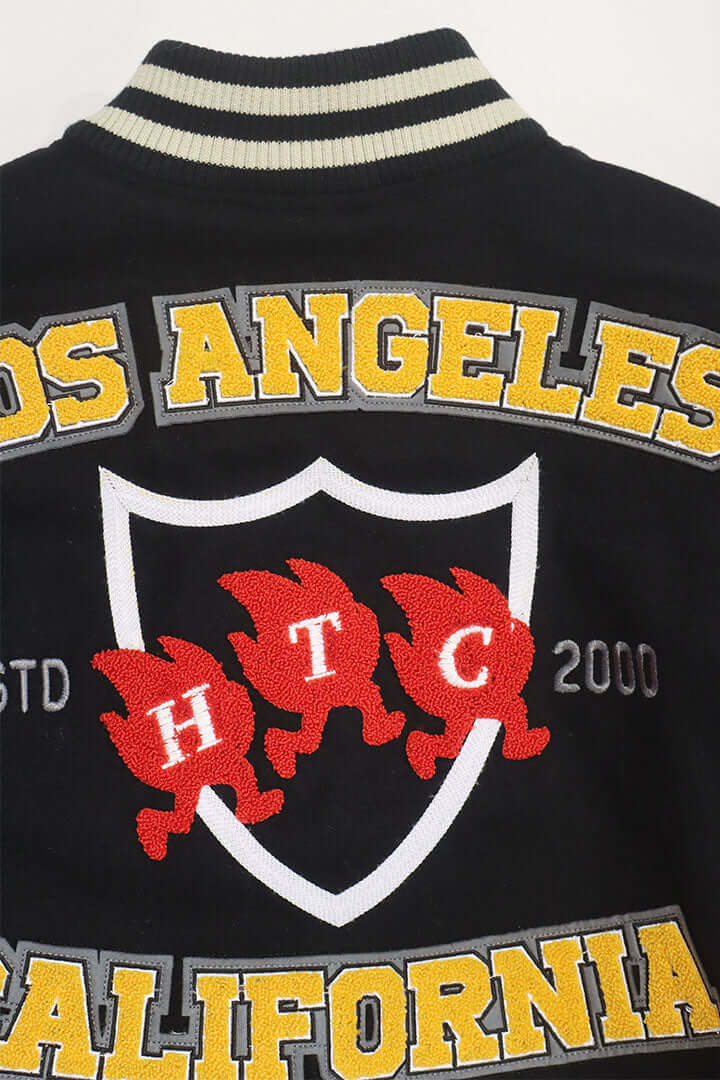 HTC LOS ANGELES HTC VARSITY JACKET BLACK HTC VARSITY JACKET BLACK Limited edition for Seoul. Varsity wool & leather bomber jacket. Front button closure, ribbed collar, cuffs and hem. Embroidered details and patches. Two side pockets. Main body composition