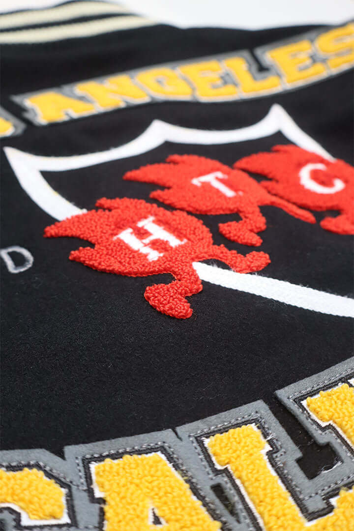 HTC LOS ANGELES HTC VARSITY JACKET BLACK HTC VARSITY JACKET BLACK Limited edition for Seoul. Varsity wool & leather bomber jacket. Front button closure, ribbed collar, cuffs and hem. Embroidered details and patches. Two side pockets. Main body composition