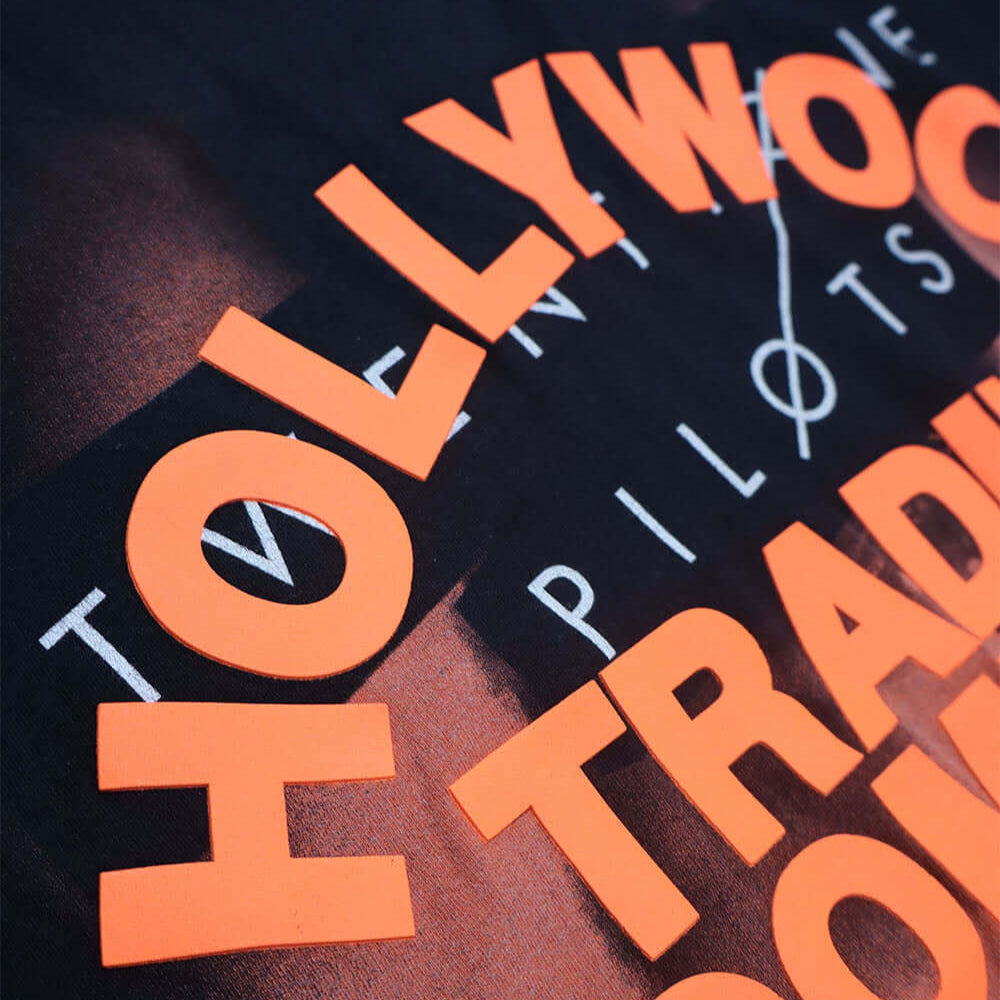 Hollywood Trading Company HTC VINTAGE 21 PILOTS T-SHIRT HTC VINTAGE 21 PILOTS T-SHIRT ONE OF A KIND VINTAGE T-SHIRT WITH ORIGINAL TWENTY ONE PILOTS PRINT, REWORKED WITH ORANGE HTC LOGO ON THE FRONT. BOXY FIT. t-shirt Hollywood Trading Company Hollywood Tr