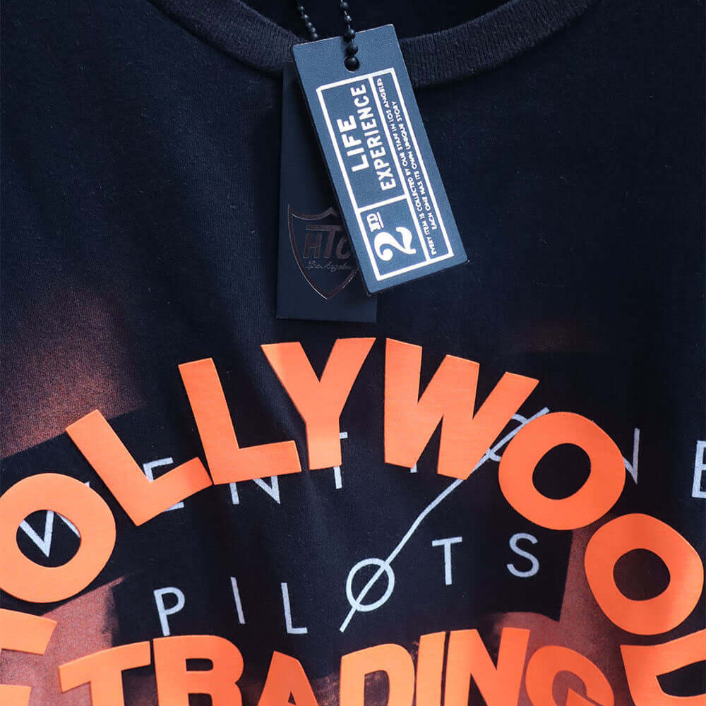 Hollywood Trading Company HTC VINTAGE 21 PILOTS T-SHIRT HTC VINTAGE 21 PILOTS T-SHIRT ONE OF A KIND VINTAGE T-SHIRT WITH ORIGINAL TWENTY ONE PILOTS PRINT, REWORKED WITH ORANGE HTC LOGO ON THE FRONT. BOXY FIT. t-shirt Hollywood Trading Company Hollywood Tr