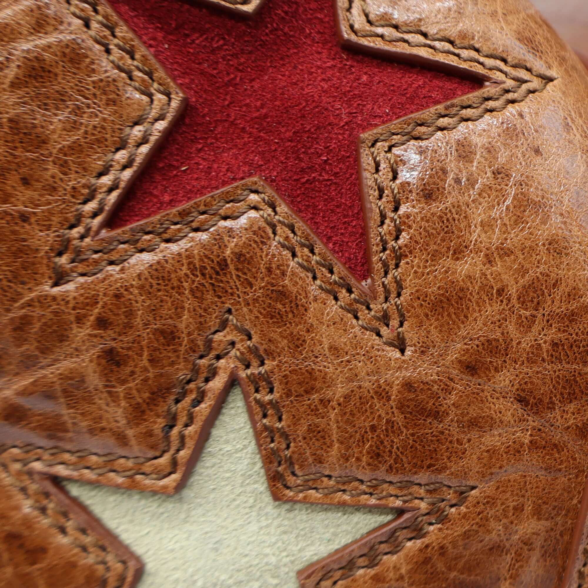 htc los angeles DEBBY STARS COGNAC Hobo bag in Cognac, featuring a zip closure along with a magnetic and buckle closure. Crafted in Italy, with star-shaped details, 100% cow leather. Hollywood Trading Company