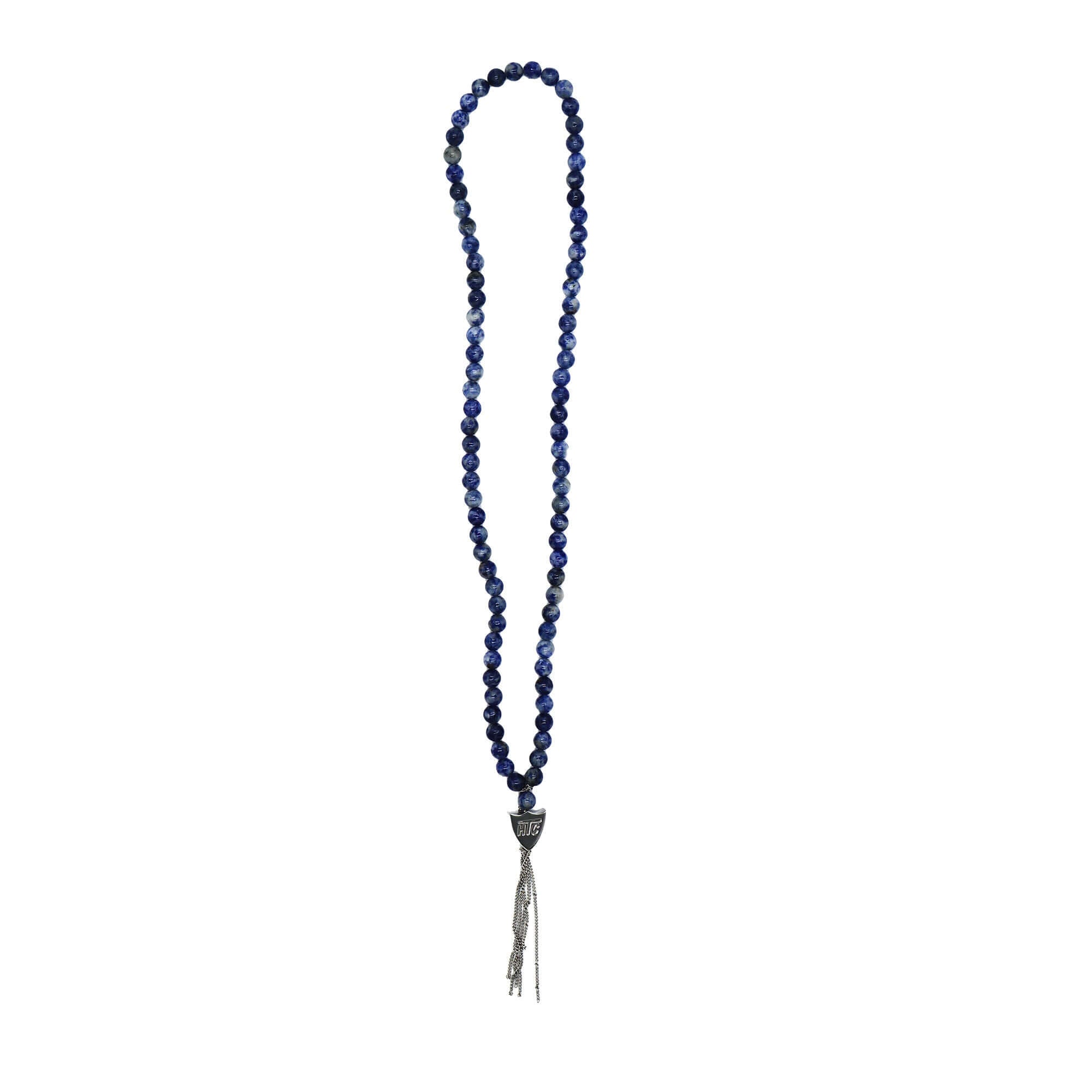 htc los angeles MYSTERY SHIELD NECKLACE SODALITE Sodalite necklace featuring a blend of textile, glass, and metal materials, with a metal HTC logo detail. Hollywood Trading Company