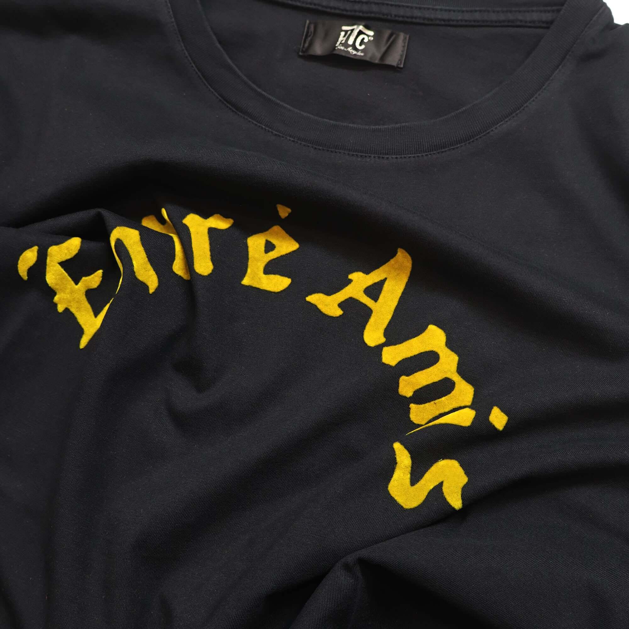 htc los angeles ENTRE AMIS T-SHIRT Black regular fit t-shirt featuring a front and back yellow flocked print. Made from 100% cotton and crafted in Italy. Hollywood Trading Company