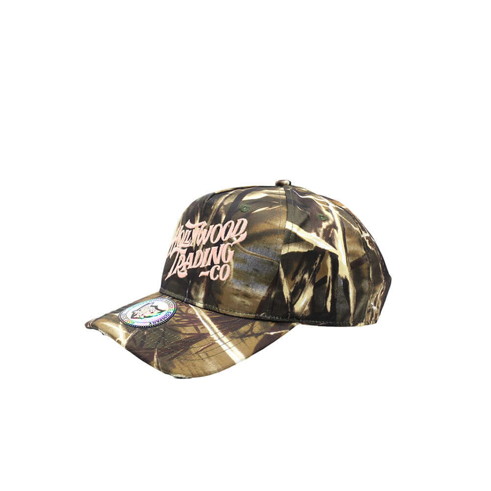 Hollywood Trading Company HOLLYWOOD T.C. CAMO CAP HOLLYWOOD T.C. CAMO CAP Baseball cap with preformed peak, round crown with eyelets, Hollywood TC embroidered on the front, adjustable strap on the back. One size fits all. 100% cotton. Hollywood Trading Co