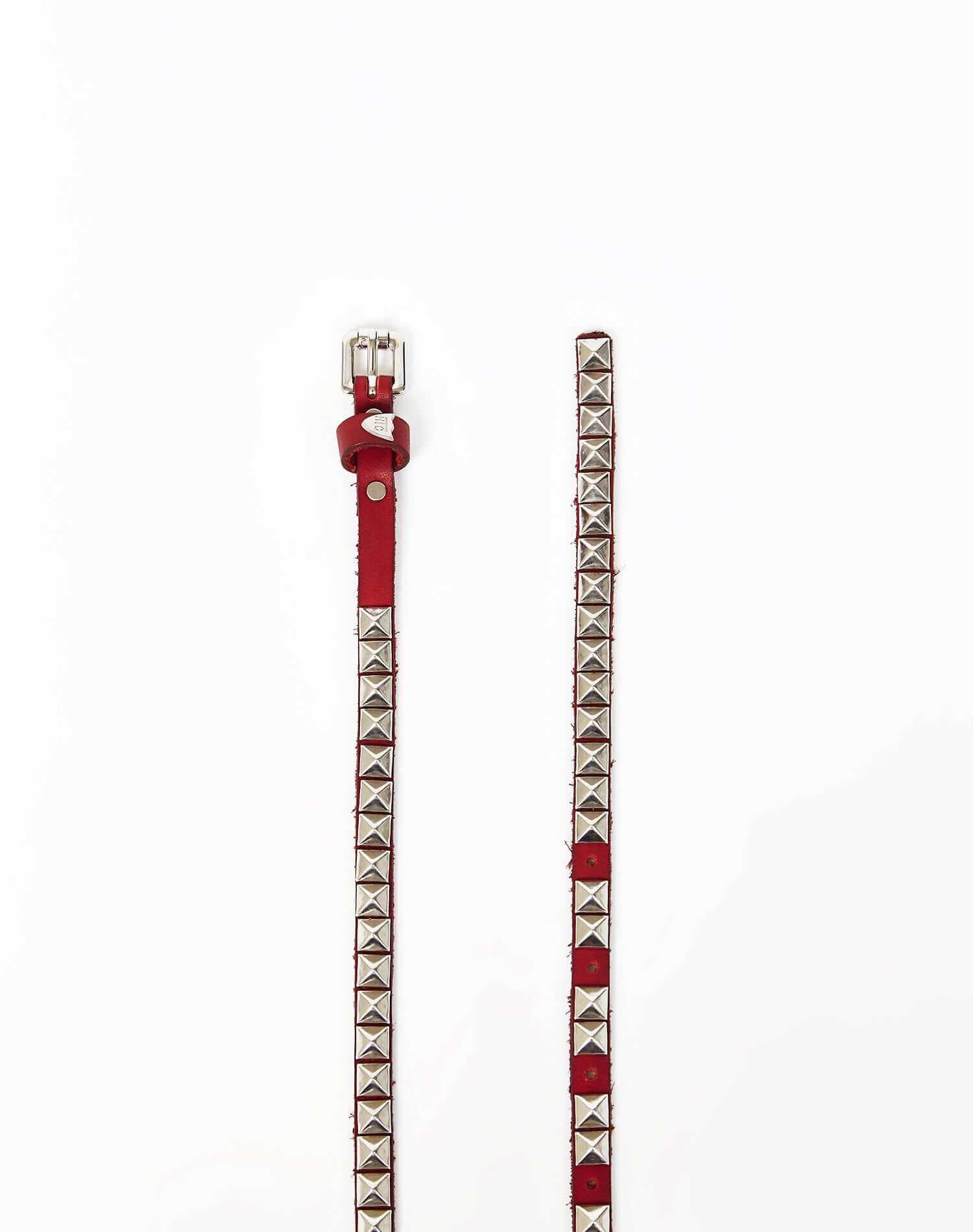 CHELSIE BELT Red leather belt with pyramidal studs, buckle and belt loop in shiny metal. Height: 1 cm. Made in Italy. HTC LOS ANGELES