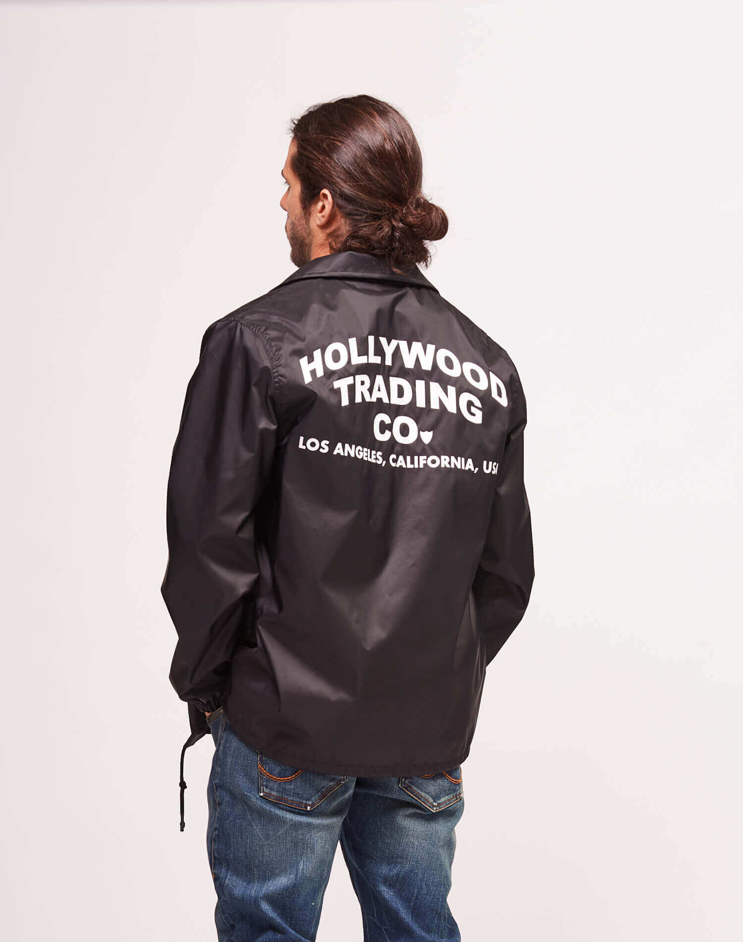COACH JACKET Coach jacket with shirt style collar. Front snap button closure. Elastic cuffs. Drawstring at hem. Two side pockets. Front logo and 'Hollywood Trading Co.' on the back. 100% Polyester HTC LOS ANGELES