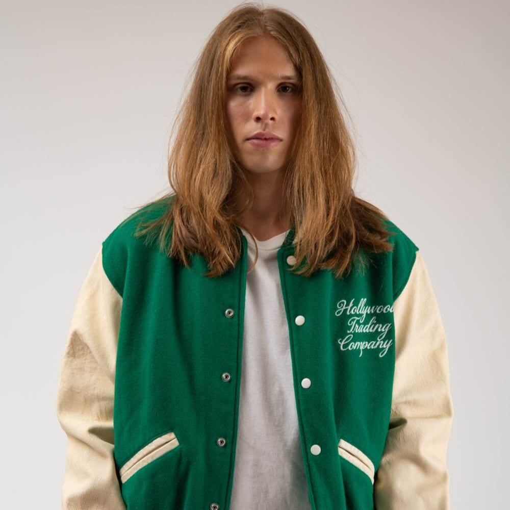 Hollywood Trading Company COLLEGE - EMBROIDERY MAN COLLEGE - EMBROIDERY MAN Varsity wool & leather bomber jacket. Front button closure, ribbed collar, cuffs and hem. Embroidered details. Two side pockets. Main body composition: 70% Wool, 30% Acrylic; slee