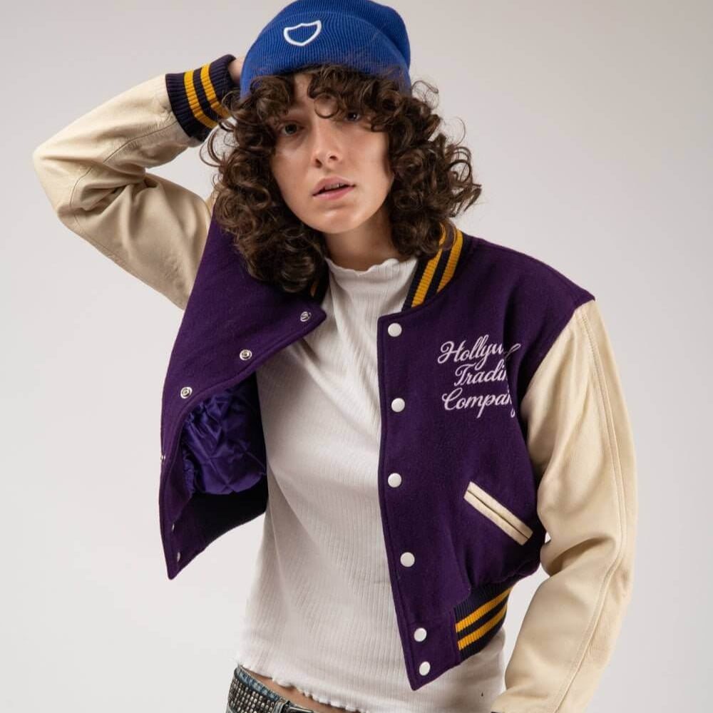 Hollywood Trading Company COLLEGE - EMBROIDERY WOMAN COLLEGE - EMBROIDERY WOMAN Varsity wool & leather bomber jacket. Front button closure, ribbed collar, cuffs and hem. Embroidered details. Two side pockets. Main body composition: 70% Wool, 30% Acrylic;