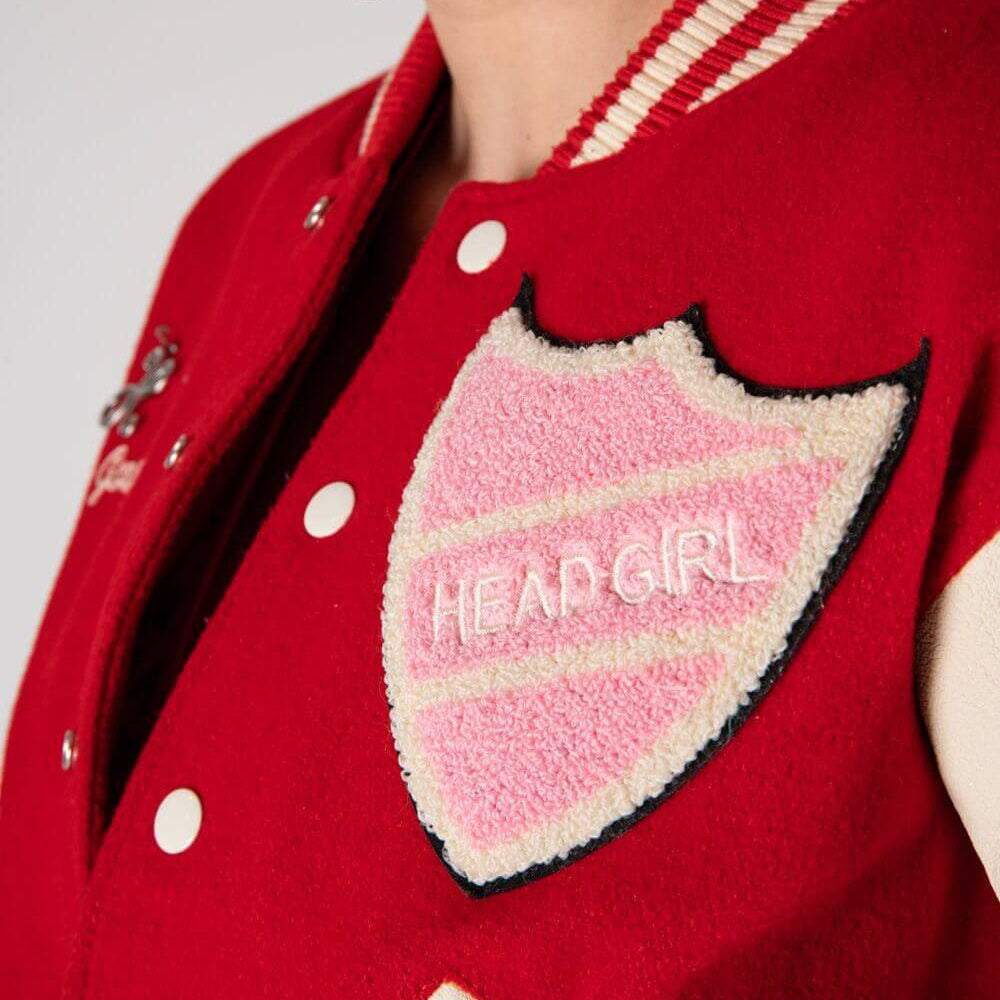 Hollywood Trading Company COLLEGE - SHIELD COLLEGE - SHIELD Varsity wool & leather bomber jacket. Front button closure, ribbed collar, cuffs and hem. Embroidered details and patches. Two side pockets. Main body composition: 70% Wool, 30% Acrylic; sleeves:
