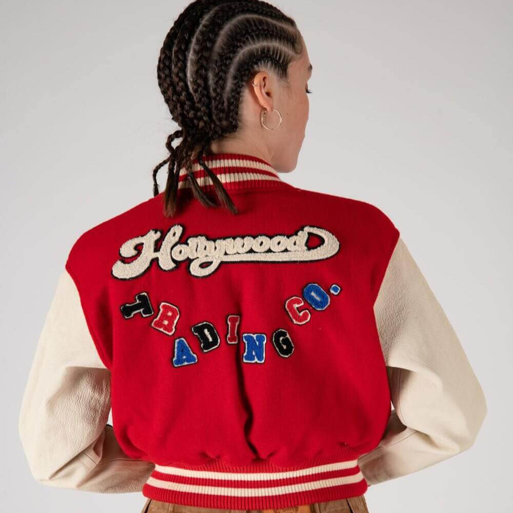 Hollywood Trading Company COLLEGE - SHIELD COLLEGE - SHIELD Varsity wool & leather bomber jacket. Front button closure, ribbed collar, cuffs and hem. Embroidered details and patches. Two side pockets. Main body composition: 70% Wool, 30% Acrylic; sleeves: