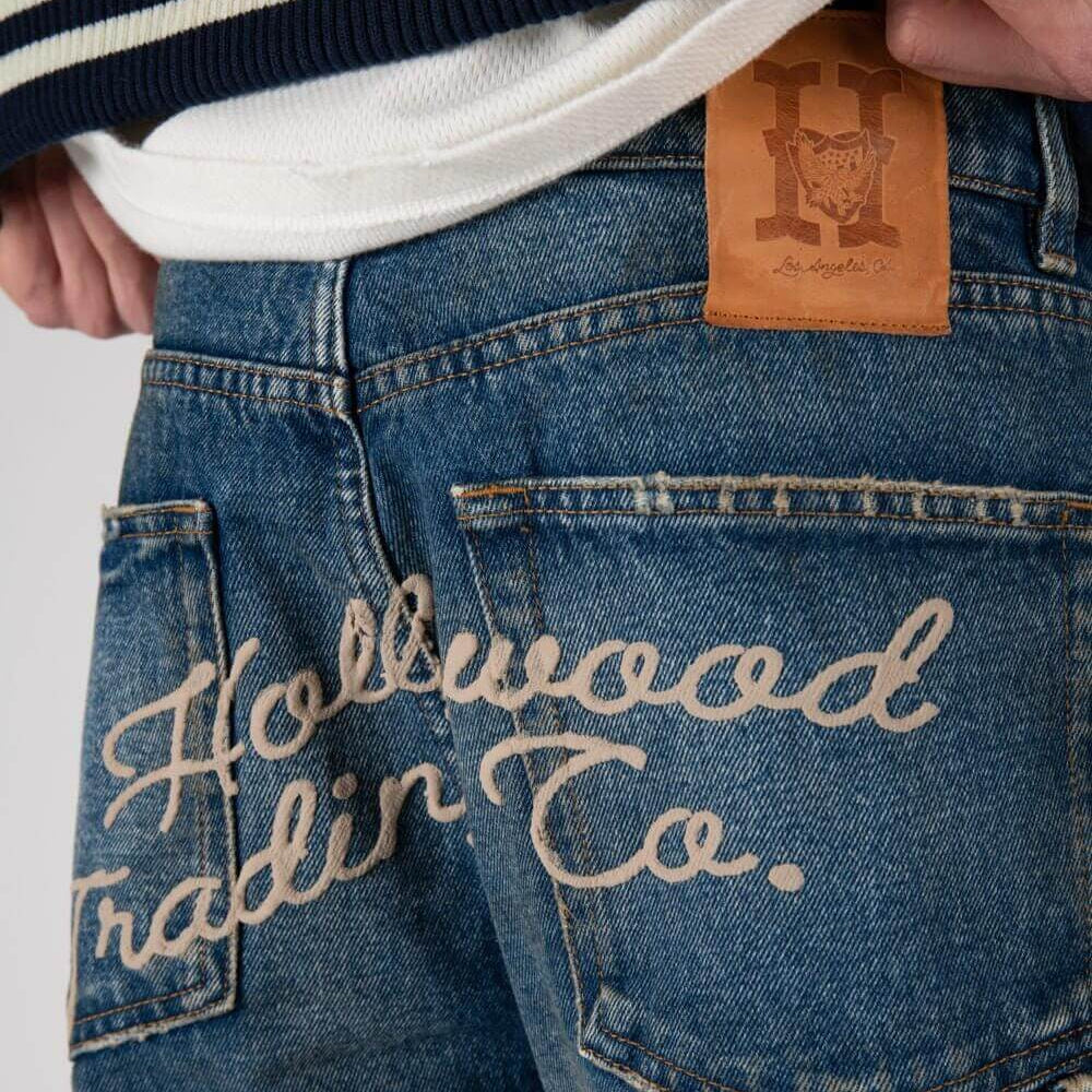 htclosangeles GATORADE - HOLLYWOOD GATORADE - HOLLYWOOD Loose fit jeans with front button and zip closure. Back embroidered logo and leather logo patch. Composition: 100% Cotton Hollywood Trading Company Hollywood Trading Company