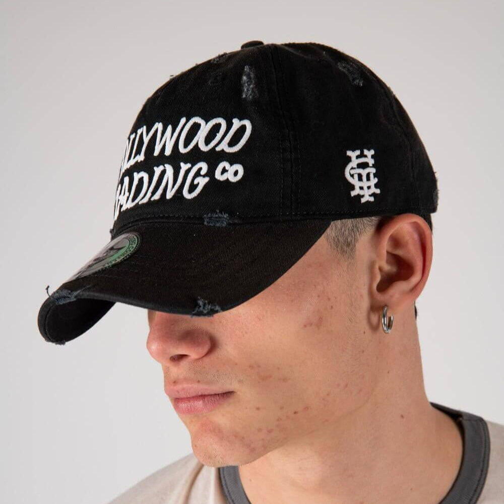 Hollywood Trading Company HOLLYWOOD T.C. BLK CAP HOLLYWOOD T.C. BLK CAP Baseball cap with preformed peak, round crown with eyelets, Hollywood TC embroidered on the front, adjustable strap on the back. One size fits all. 100% cotton. Hollywood Trading Comp