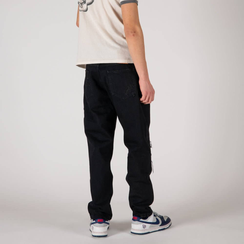 Hollywood Trading Company LOOSE LOOSE Loose fit jeans with front button and zip closure. Back leather logo patch. Intentionally distressed areas may vary. Five pockets. Hem: 17 cm. Composition: 100% Cotton PANTS Hollywood Trading Company Hollywood Trading