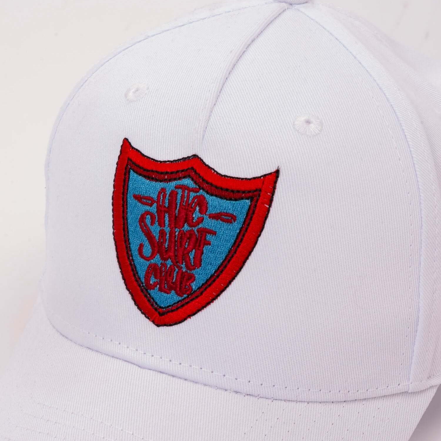 htclosangeles SURF CLUB CAP SURF CLUB CAP Limited Edition Black baseball cap with preformed peak, round crown with eyelets,'HTC SURF CLUB' logo printed on the front, adjustable strap on the back. One size fits all. 100% cotton. Hollywood Trading Company H
